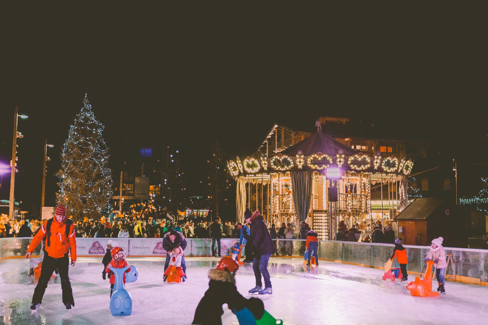 Groups of families enjoying ice skating in Morzine ski resort